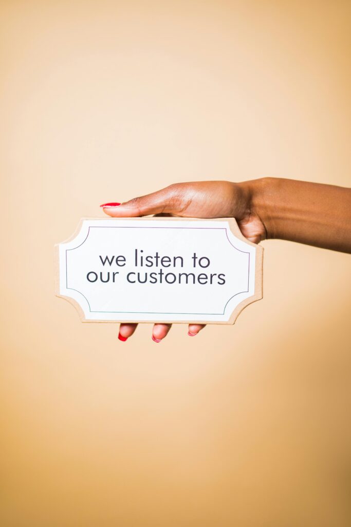 A hand holding a sign saying 